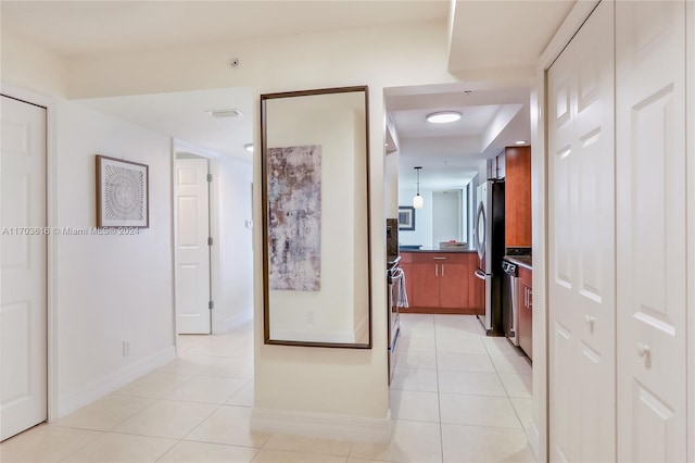 hallway featuring light tile patterned floors