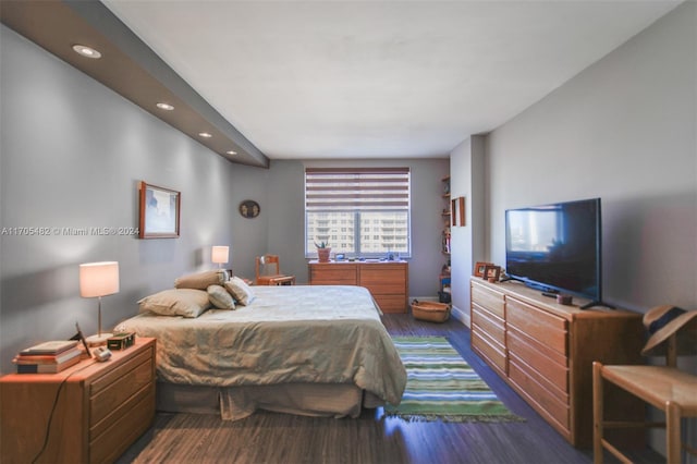 bedroom with dark hardwood / wood-style flooring