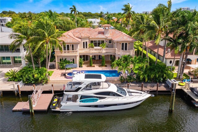 rear view of house with a patio area and a water view