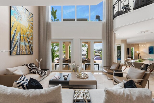 living room with french doors and a high ceiling