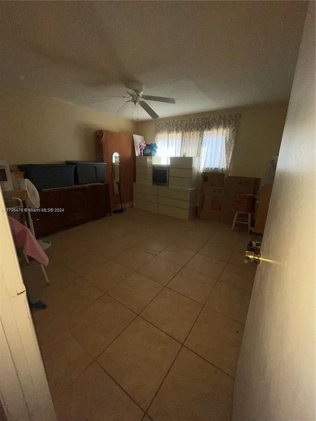 bedroom featuring tile patterned floors and ceiling fan