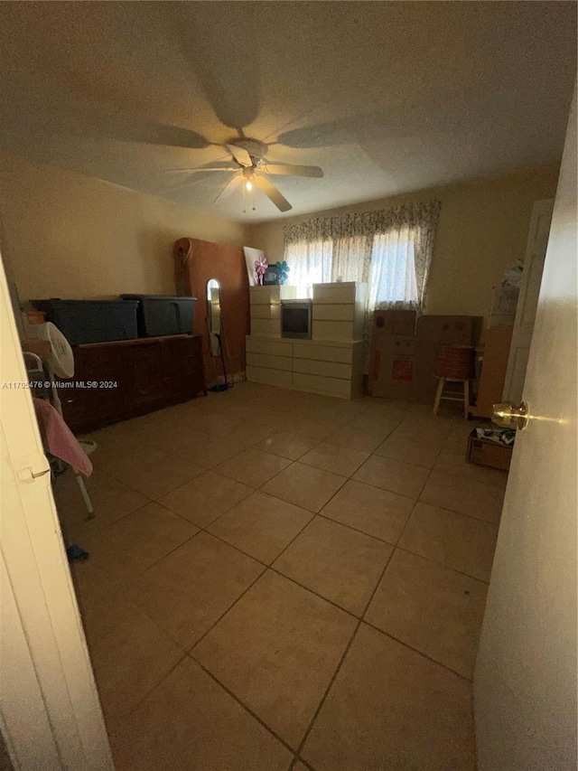 tiled bedroom with ceiling fan