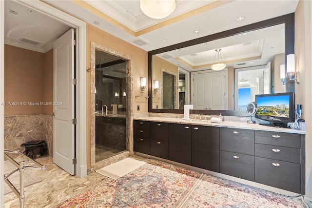 bathroom featuring vanity, crown molding, walk in shower, and a tray ceiling