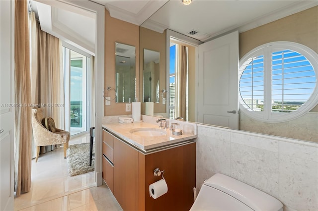 bathroom with tile patterned floors, vanity, ornamental molding, and toilet