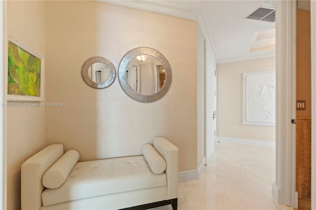 sitting room with crown molding and light tile patterned flooring