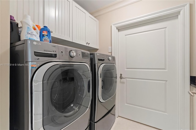 clothes washing area featuring cabinets, independent washer and dryer, and ornamental molding