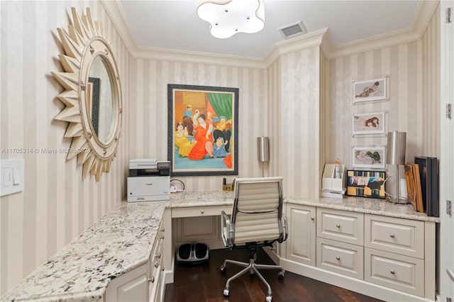 office with crown molding, built in desk, and dark hardwood / wood-style floors