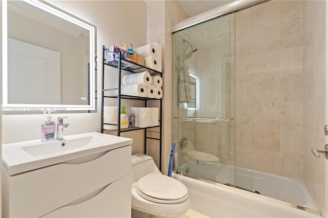 full bathroom featuring vanity, enclosed tub / shower combo, and toilet