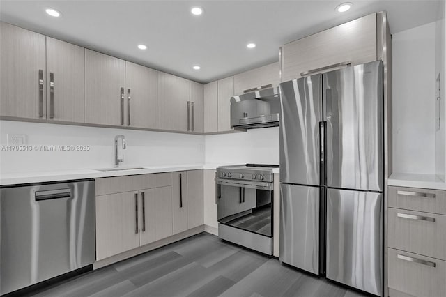 kitchen featuring appliances with stainless steel finishes, dark wood-type flooring, and sink