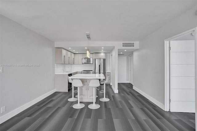 dining space featuring sink and dark wood-type flooring