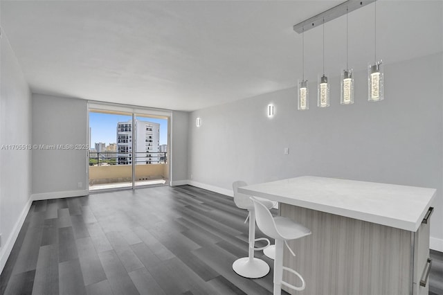 unfurnished dining area featuring floor to ceiling windows and dark wood-type flooring