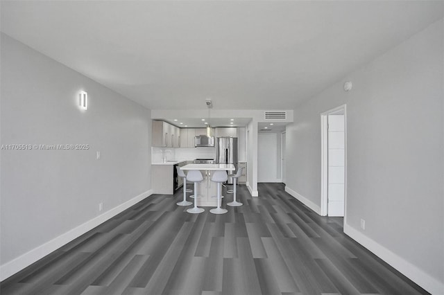 unfurnished living room with dark hardwood / wood-style floors and sink