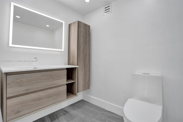 bathroom with vanity and toilet