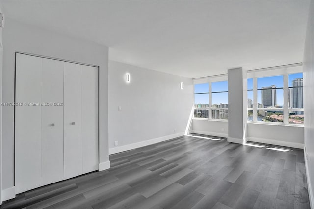 unfurnished bedroom featuring dark hardwood / wood-style flooring and a closet