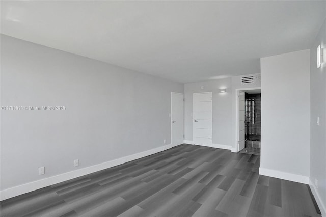 empty room with dark hardwood / wood-style floors