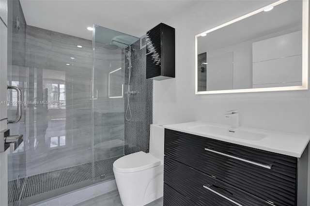 bathroom with an enclosed shower, vanity, and toilet