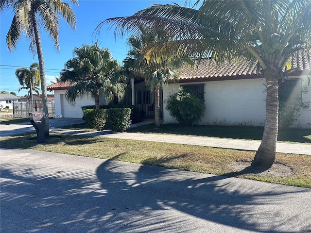 view of front of property with a front yard and a garage