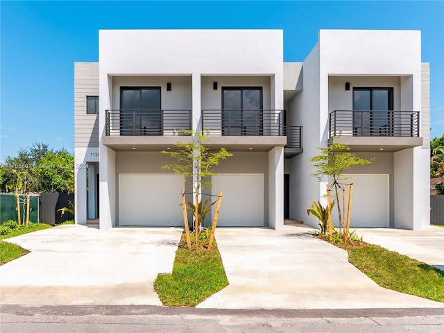 view of front of home with a garage and a balcony