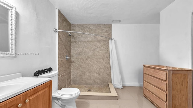 bathroom featuring tile patterned floors, vanity, toilet, and walk in shower