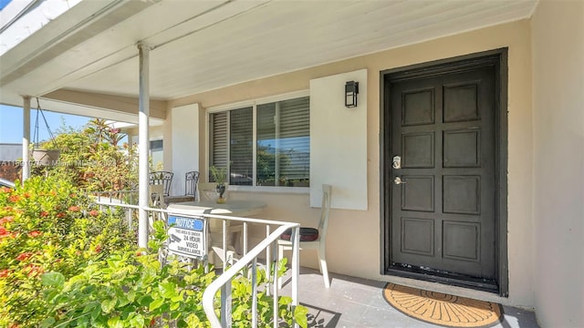 doorway to property featuring covered porch