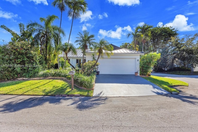 view of front of property featuring a garage and a front lawn