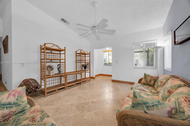 living room featuring a textured ceiling and ceiling fan