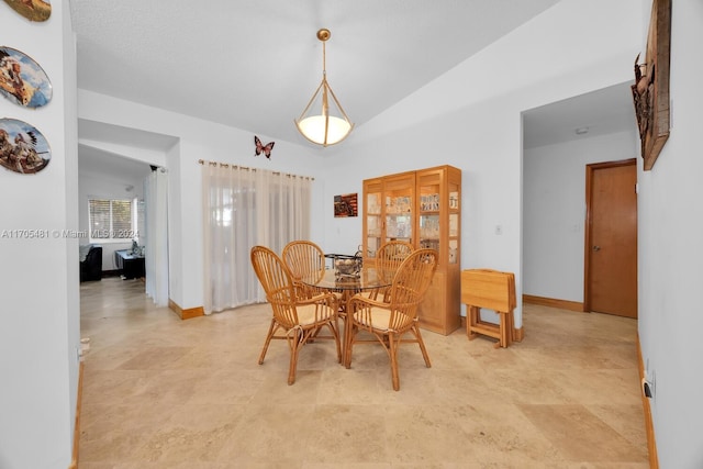 dining space featuring lofted ceiling