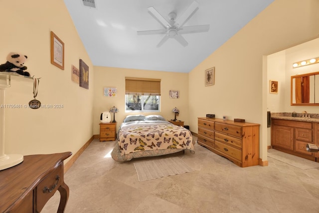 bedroom with ensuite bathroom, ceiling fan, sink, and vaulted ceiling