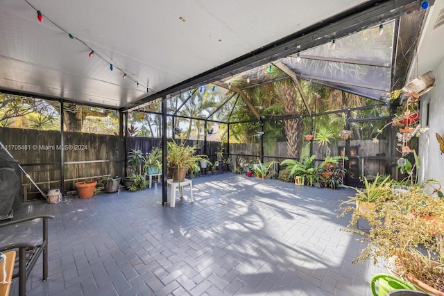 unfurnished sunroom with lofted ceiling