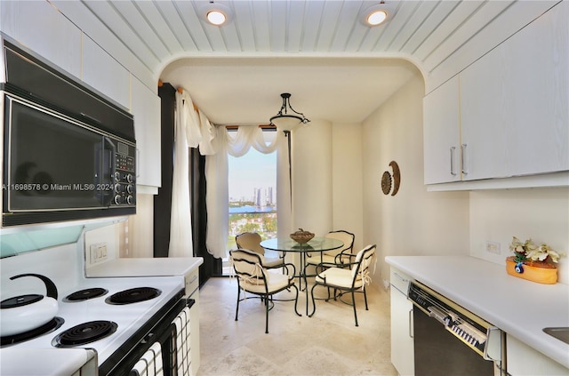 kitchen with pendant lighting, white cabinetry, and black appliances