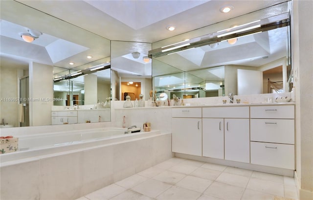 bathroom featuring vanity, tiled bath, and tile patterned floors