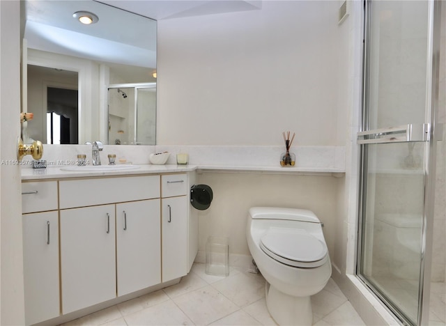 bathroom with tile patterned floors, vanity, an enclosed shower, and toilet