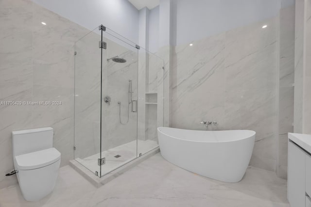 full bathroom featuring vanity, toilet, tile walls, and independent shower and bath