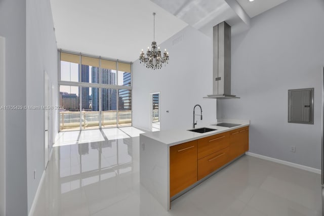 kitchen with sink, wall chimney range hood, electric panel, a chandelier, and black electric cooktop