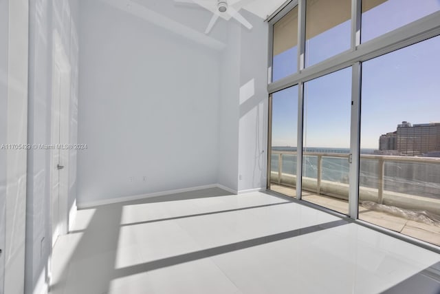 spare room featuring tile patterned flooring and ceiling fan