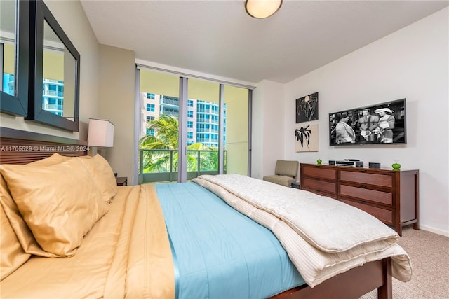 carpeted bedroom featuring access to exterior