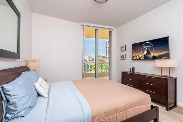 carpeted bedroom with access to outside and a textured ceiling