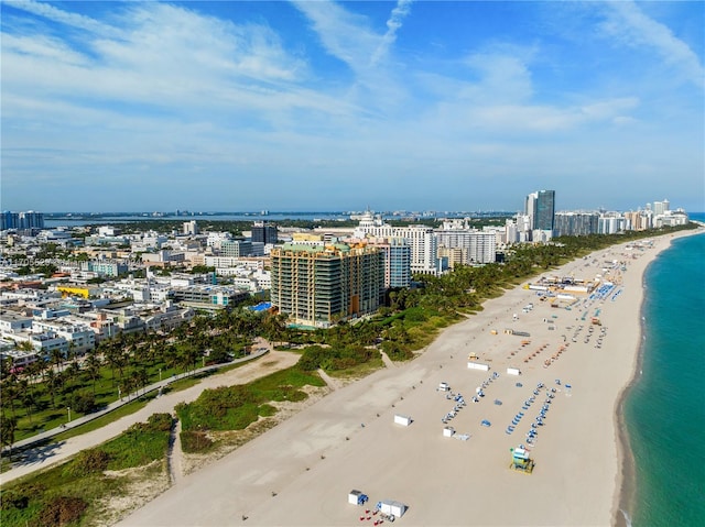 drone / aerial view featuring a water view and a view of the beach