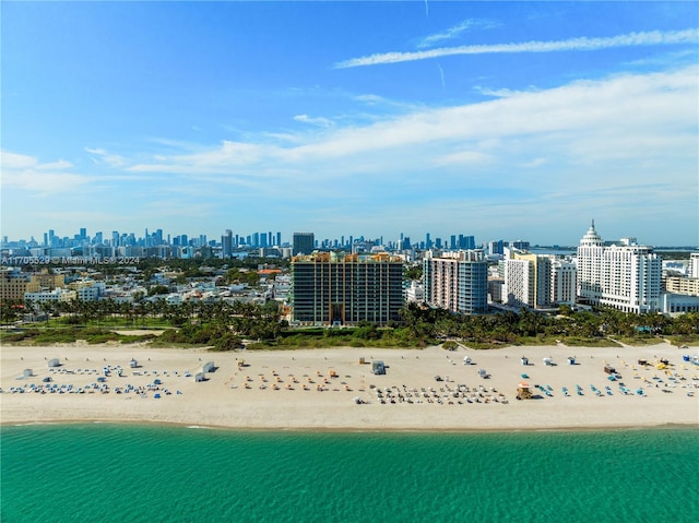 drone / aerial view featuring a view of the beach and a water view