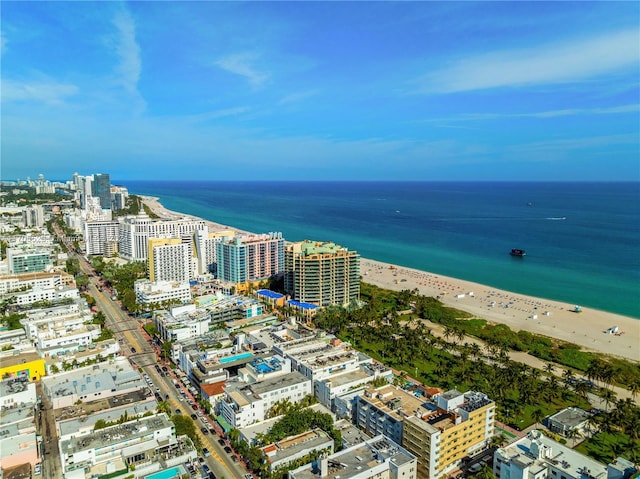 drone / aerial view featuring a water view and a beach view