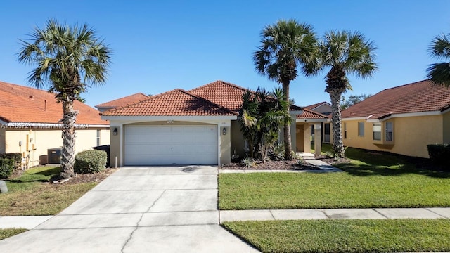 mediterranean / spanish-style home with central AC, a front lawn, and a garage