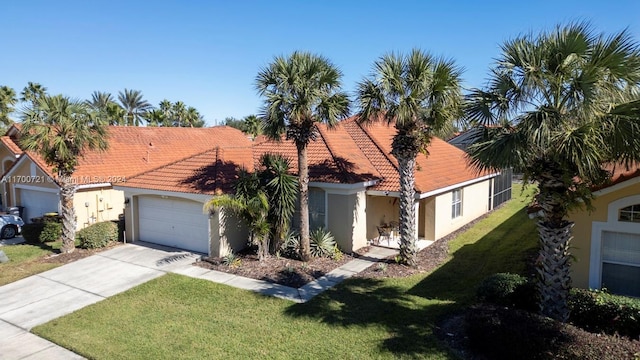 mediterranean / spanish home with a garage and a front yard