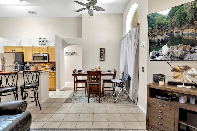 tiled dining room featuring ceiling fan