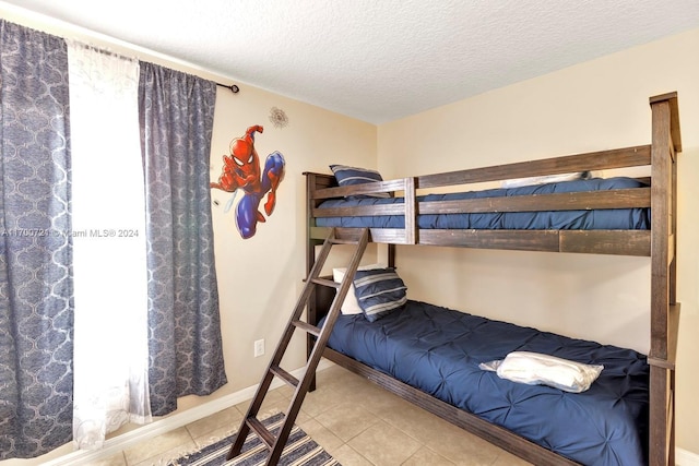 tiled bedroom with a textured ceiling