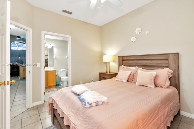 bedroom with connected bathroom, ceiling fan, and light tile patterned flooring