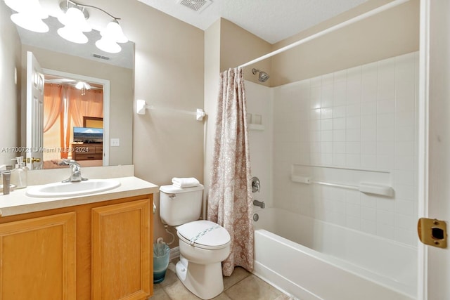 full bathroom with tile patterned floors, shower / bath combination with curtain, a textured ceiling, toilet, and vanity