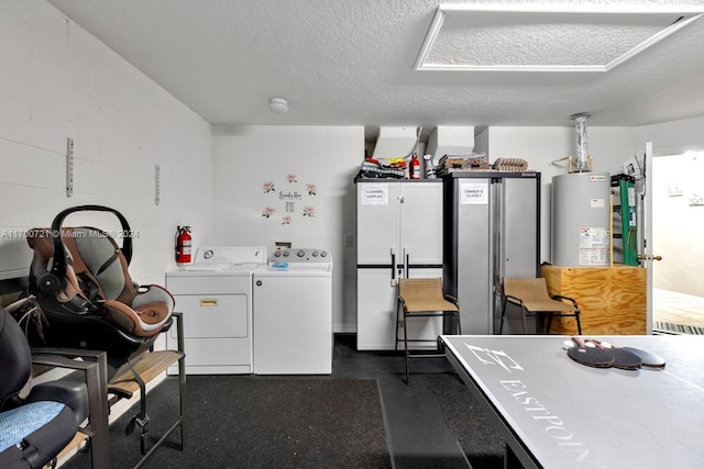 kitchen featuring refrigerator, a textured ceiling, gas water heater, washer and dryer, and white cabinetry