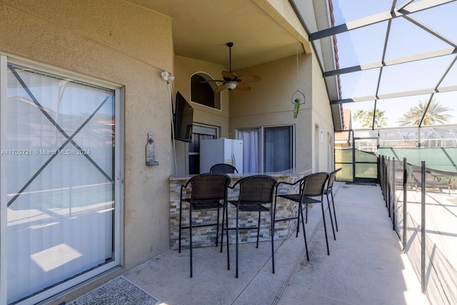 view of patio featuring a lanai and ceiling fan