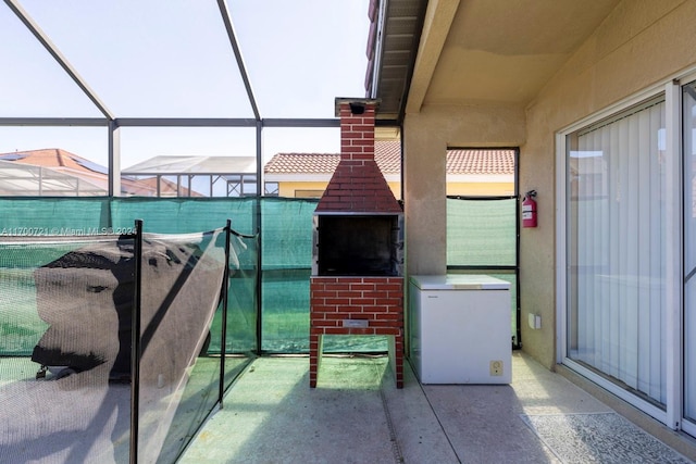 view of patio featuring a lanai