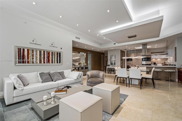 living room featuring a tray ceiling